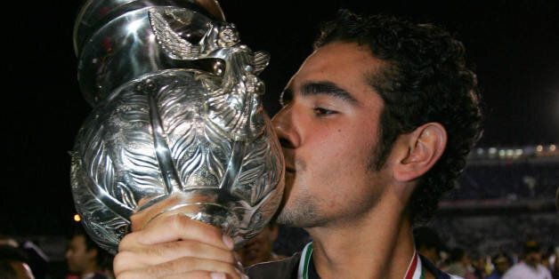 MONTERREY, MEXICO: Pumas soccer player Hugo Sanchez Portugal, kissed the trophy during celebrated his victory during their final game for the Mexican first division Tournament, against Monterrey team, at the Tecnologic Stadium, in Monterrey, Nuevo Leon 11 december 2004. AFP PHOTO/Alfredo ESTRELLA (Photo credit should read ALFREDO ESTRELLA/AFP/Getty Images)