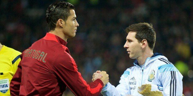 MANCHESTER, ENGLAND - NOVEMBER 18 : Argentina's captain Lionel Messi (R) shakes hand with Portugal's Cristiano Ronaldo (L) before the international friendly football match between Argentina and Portugal at Old Trafford in Manchester on November 18, 2014. (Photo by David Rawcliffe/Anadolu Agency/Getty Images)