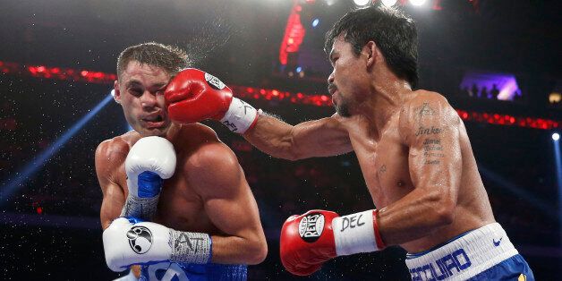 WBO welterweight champion Manny Pacquiao, right, of the Philippines lands a right on the face of WBO junior welterweight champion Chris Algieri of the United States during their welterweight boxing title fight at the Venetian Macao in Macau, Sunday, Nov. 23, 2014. (AP Photo/Kin Cheung)