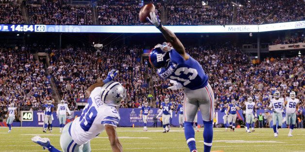 New York Giants wide receiver Odell Beckham Jr. (13) makes a one-handed catch for a touchdown against Dallas Cowboys cornerback Brandon Carr (39) in the second quarter of an NFL football game, Sunday, Nov. 23, 2014, in East Rutherford, N.J. (AP Photo/Julio Cortez)