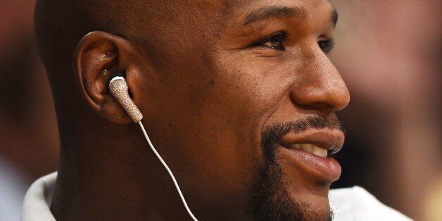 Boxer Floyd Mayweather Jr attends the Los Angeles Lakers vs Houston Rockets NBA game, October 28, 2014 at Staples Center in Los Angeles, California. AFP PHOTO / Robyn Beck (Photo credit should read ROBYN BECK/AFP/Getty Images)