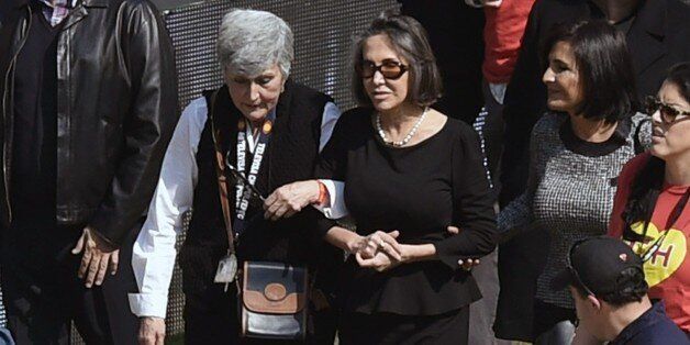 The widow of Mexican comedian Roberto Gomez Bolanos, Florinda Meza (C-R), attends an homage to him at the 105,000-capacity Azteca stadium in Mexico City, on November 30, 2014, two days after his death. Comedy icon Gomez Bolanos, commonly known by his pseudonym 'Chespirito' and for starring in the television series 'El Chapulin Colorado' and 'El Chavo del Ocho' died Friday aged 85. AFP PHOTO / Alfredo ESTRELLA (Photo credit should read ALFREDO ESTRELLA/AFP/Getty Images)