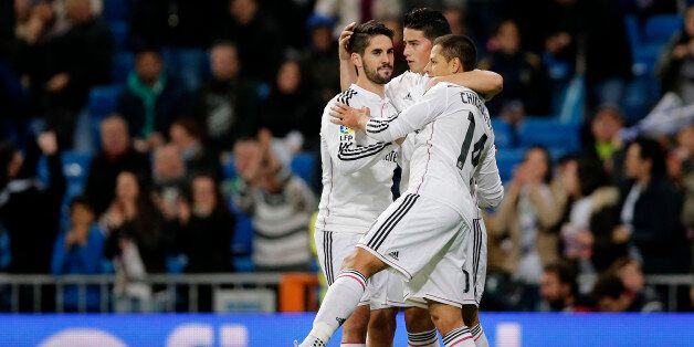 Real Madridâs James from Colombia, center, celebrates scoring with teammates Chicharito from Mexico, right, and Isco during the Spanish Kingâs Cup soccer match against Cornella at the Bernabeu stadium in Madrid, Spain, Tuesday Dec. 2, 2014. (AP Photo/Daniel Ochoa de Olza)