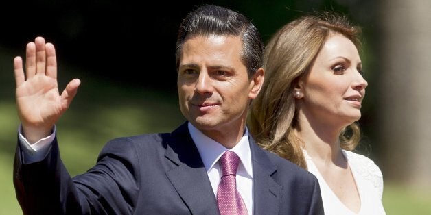 Mexican President Enrique Pena Nieto (L) next to his wife Angelica Rivera waves at the press in Vina Del Mar, Chile on March 11, 2014 after Chilean President Michelle Bachelet's inauguration. Socialist Bachelet took the oath of office as president of Chile Tuesday, returning to power after four years with a reform agenda to reduce social disparities in this prosperous South American countrywave to the press at Cerro Castillo Palace in Vina Del Mar, on March 11, 2014 after Bachelet's inauguration. AFP/Claudio Reyes (Photo credit should read Claudio Reyes/AFP/Getty Images)