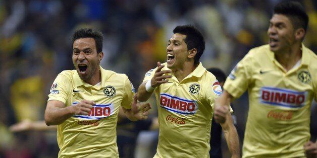 Players of America celebrate their goal against Pumas, during their Mexican Apertura football tournament 2014 at the Azteca Stadium, in Mexico City, on November 29, 2014. AFP PHOTO/ALFREDO ESTRELLA (Photo credit should read ALFREDO ESTRELLA/AFP/Getty Images)