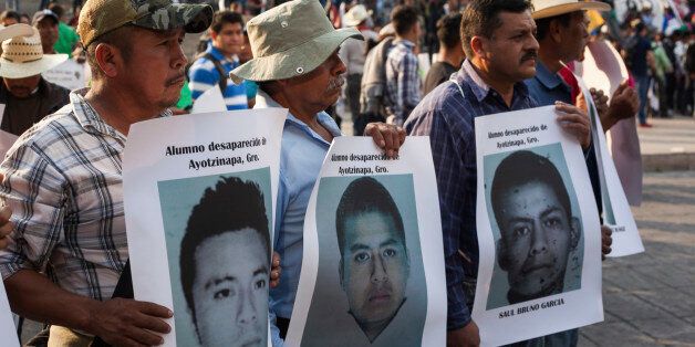MEXICO CITY, MEXICO - DECEMBER 06: Protesters hold photographies of some of the missing students during a march to demand justice for the 43 missing students from Ayotzinapa in the Mexican state of Guerrero on December 06, 2014 in Mexico City, Mexico. the Argentinian forensic team in charge of the DNA analysis of the remains has confirmed that one of the bodies that were found in the garbage dump belongs to Alexander Mora Venancio one of the missing students. (Photo by Oswaldo Ramirez/LatinContent/Getty Images)