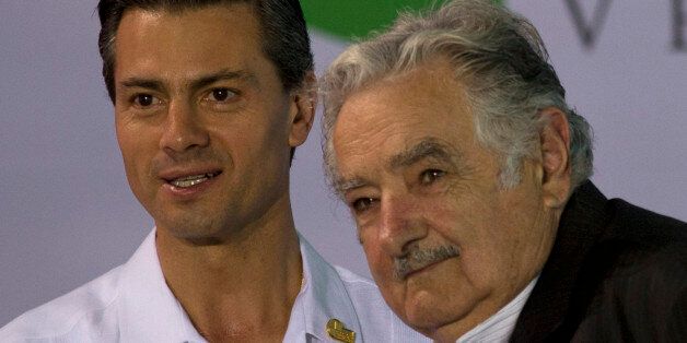 Uruguay's President Jose Mujica, right, poses for a photo with Mexico's President Enrique Pena Nieto as he arrives for the opening ceremony of the Iberoamerican Summit in Veracruz, Mexico, Monday, Dec. 08, 2014. Veracruz is hosting the 2014 Iberoamerican Summit, an annual meeting of heads of state from Latin America and the Iberian Peninsula. (AP Photo/Rebecca Blackwell)