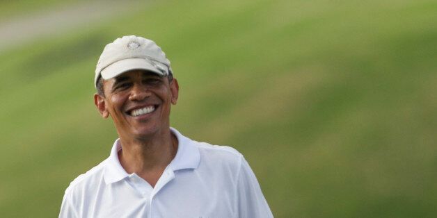 President Barack Obama plays golf at the Mid Pacific Country Club, Wednesday, .Jan. 1, 2014 in Lanikai on the island of Oahu, in Hawaii. (AP Photo/Marco Garcia)
