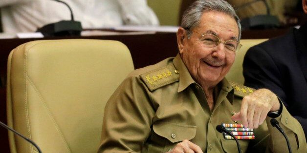 Cuba's President Raul Castro, front, smiles during a twice-annual legislative session at the National Assembly in Havana, Cuba, Friday, Dec. 19, 2014. After the Wednesday announcement that the U.S. and Cuba would resume diplomatic relations for the first time since 1961, Castro said he still wants an end to the trade embargo that has choked off commerce to the island and has kept generations of Americans from being able to visit. At right is Vice President Miguel Diaz Canel. (AP Photo/Ismael Francisco, Cubadebate)