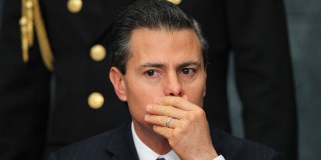 Mexico's President Enrique Pena Nieto listens to speakers during the 2014 Human Rights prize ceremony at the Los Pinos presidential residence in Mexico City, Friday, Dec. 12, 2014. President Barack Obama said this week that the U.S. has offered to help Mexico figure out what happened to 43 college students who have been missing since September, but he stopped short of saying that aid to the U.S. ally and neighbor should be reconsidered on the basis of the country's human rights record. (AP Photo/Marco Ugarte)
