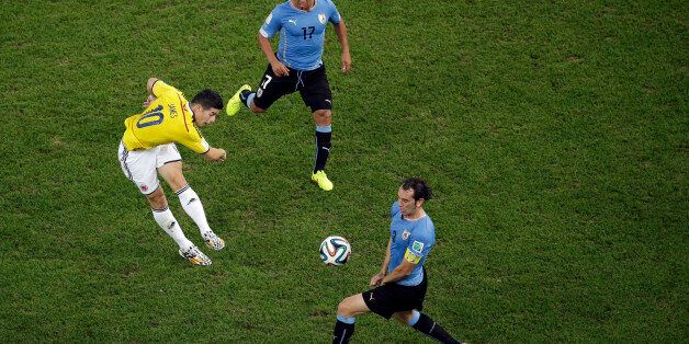 Colombia's James Rodriguez, left, scores the opening goal past Uruguay's Diego Godin, front, as Uruguay's Egidio Arevalo Rios gives chase during the World Cup round of 16 soccer match between Colombia and Uruguay at the Maracana Stadium in Rio de Janeiro, Brazil, Saturday, June 28, 2014. (AP Photo/Felipe Dana, pool)