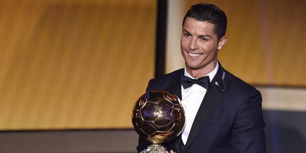 Real Madrid and Portugal forward Cristiano Ronaldo smiles after receiving the 2014 FIFA Ballon d'Or award for player of the year during the FIFA Ballon d'Or award ceremony at the Kongresshaus in Zurich on January 12, 2015. AFP PHOTO / FABRICE COFFRINI (Photo credit should read FABRICE COFFRINI/AFP/Getty Images)