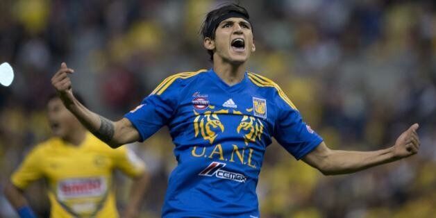 Tigres' forward Alan Pulido celebrates after scoring a goal against America during their Mexican Apertura 2013 tournament quarterfinal football match at the Azteca stadium in Mexico City on December 1, 2013. AFP PHOTO/ Yuri CORTEZ (Photo credit should read YURI CORTEZ/AFP/Getty Images)