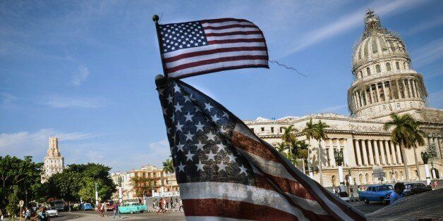 US flags are seen in a bici-taxi near the capitol in Havana on January 23, 2015. Hours into historic US-Cuba talks in Havana, a Cuban official came out to boast about the 'relaxed' atmosphere at the meeting between the old Cold War adversaries. After barely speaking face-to-face since the 1960s, the United States and Cuba took big steps toward normalizing ties by holding a two-day meeting, even though the talks highlighted enduring rifts between the nations. AFP PHOTO / Yamil LAGE (Photo credit should read YAMIL LAGE/AFP/Getty Images)