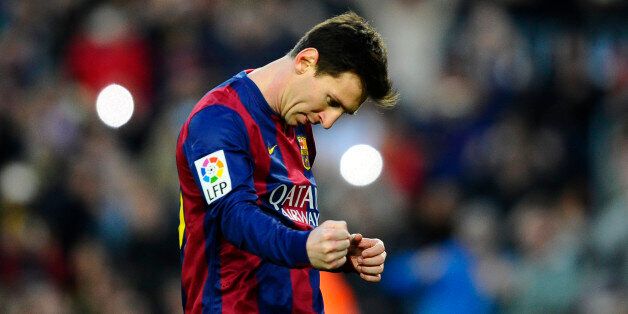 FC Barcelona's Lionel Messi, from Argentina, reacts after scoring against Levante during a Spanish La Liga soccer match at the Camp Nou stadium in Barcelona, Spain, Sunday, Feb. 15, 2015. (AP Photo/Manu Fernandez)