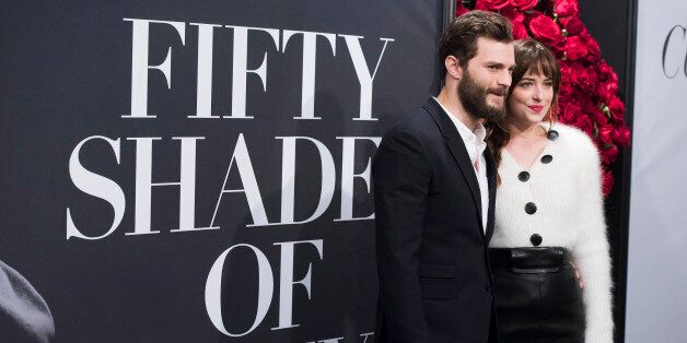 Jamie Dornan and Dakota Johnson attend a special fan screening of "Fifty Shades of Grey" hosted by The Today Show at the Ziegfeld Theatre on Friday, Feb. 6, 2015, in New York. (Photo by Charles Sykes/Invision/AP)