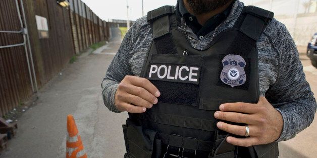 A U.S. Immigration and Customs Enforcement (ICE) agent waits as an undocumented man, not pictured, is deported to Mexico at the U.S.-Mexico border in San Diego, California, U.S., on Thursday, Feb. 26, 2015. The U.S. Department of Homeland Security is nearing a partial shutdown as the agency's funding is set to expire Friday -- something Senate Majority Leader Mitch McConnell had said wouldn't happen on his watch. Photographer: David Maung/Bloomberg via Getty Images