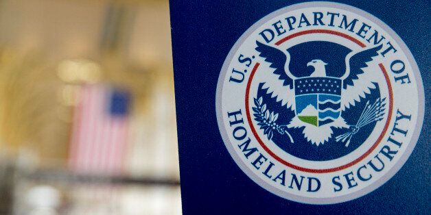 A U.S. Department of Homeland Security (DHS) sign stands at Ronald Reagan National Airport (DCA) in Washington, D.C., U.S., on Wednesday, Feb. 25, 2015. Financing for the DHS is set to lapse after Friday and the agency would face a partial shutdown unless Congress provides new money. More than 200,000 government employees deemed essential at DHS, including Transportation Security Administration (TSA) officers, would still have to report to their posts, even though their pay would stop unless Congress finds a solution. Photographer: Andrew Harrer/Bloomberg via Getty Images