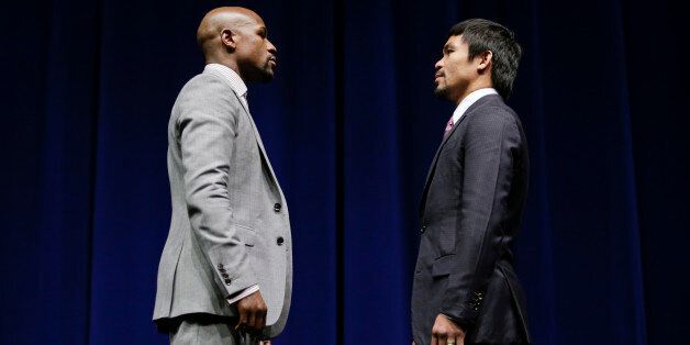 Boxers Floyd Mayweather Jr., left, and Manny Pacquiao, of the Philippines, pose for photos during a news conference, Wednesday, March 11, 2015, in Los Angeles. The two are scheduled to fight in Las Vegas on May 2. (AP Photo/Jae C. Hong)