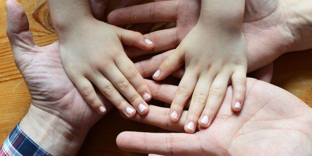 Hands of a homosexual couple and a child are pictured in Berlin, Germany, 11 April 2013. Photo: Jens Kalaene- MODEL RELEASED