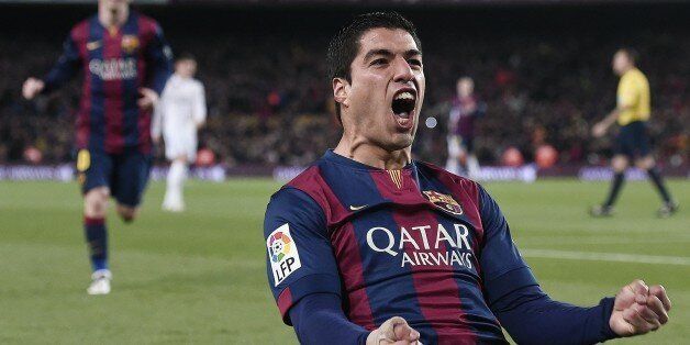 Barcelona's Uruguayan forward Luis Suarez (R) celebrates his goal during the 'clasico' Spanish league football match FC Barcelona vs Real Madrid CF at the Camp Nou stadium in Barcelona on March 22, 2015. AFP PHOTO / JOSEP LAGO (Photo credit should read JOSEP LAGO/AFP/Getty Images)