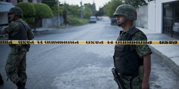 Mexican soldiers are displayed nearby Televisa TV network after a car bomb exploded with no casualties, early Friday in the northeastern city Ciudad Victoria, Tamaulipas state on August 27, 2010. The Gulf of Mexico drug cartel has been engaged in a bitter turf war for control of Tamaulipas smuggling routes into the United States with the Zetas drug cartel. AFP PHOTO/Ronaldo Schemidt (Photo credit should read Ronaldo Schemidt/AFP/Getty Images)