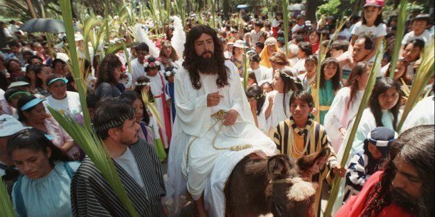 Mario Flores Galicia portrays Jesus Christ riding on a donkey in a Palm Sunday procession in the neighborhood of Iztapalapa, Sunday March 23, 1997, in Mexico City. Palm Sunday marks the beginning of Holy Week, leading up to Easter Sunday. (AP Photo/Jose Luis Magana)