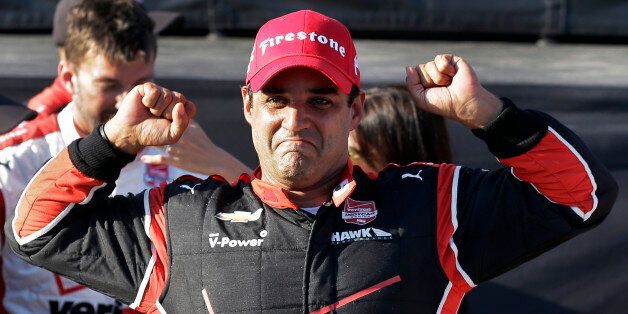 Juan Pablo Montoya, of Colombia, celebrates after winning the IndyCar Firestone Grand Prix of St. Petersburg auto race Sunday, March 29, 2015, in St. Petersburg, Fla. (AP Photo/Chris O'Meara)