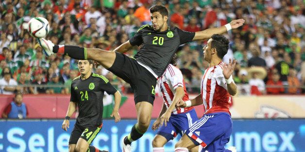 KANSAS CITY, UNITED STATES - MARCH 31: Eduardo Herrera of Mexico shoots to score the first goal of his team during an international friendly match between Paraguay and Mexico at Arrowhead Stadium on March 31, 2015 in Kansas City, United States. (Photo by Omar Vega/LatinContent/Getty Images)