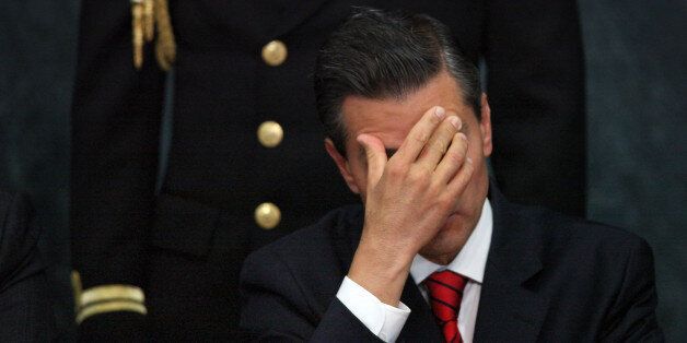 In this Wednesday, Jan. 21, 2015 photo, Mexico's President Enrique Pena Nieto attends a ceremony promoting housing for low income families, single mothers and members of the armed forces, at Los Pinos presidential residence in Mexico City. Pena Nieto faces new questions about his personal assets after a report surfaced that he purchased a home from a businessman whose company won public works contracts worth millions of dollars. It is the third time in recent months that Pena Nieto, family members or associates have come under scrutiny for real estate linked to companies doing business with the government. (AP Photo/Marco Ugarte)