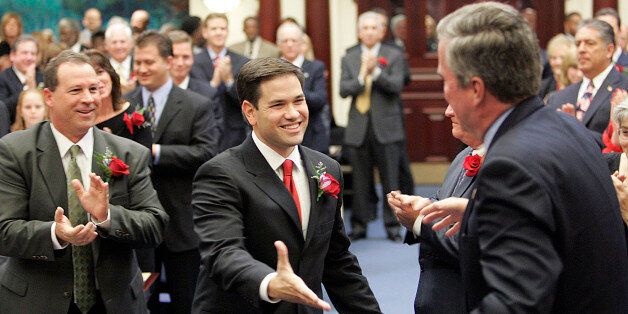 Marco Rubio, R-Coral Gables, center, the new speaker of the Florida House, greets Florida Gov. Jeb Bush, on his way to being sworn in, Tuesday, Nov. 21, 2006, in Tallahassee, Fla. (AP Photo/Steve Cannon)