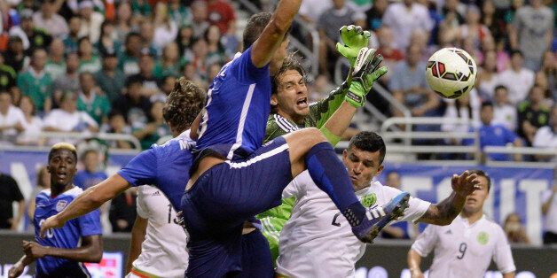 Mexico goalkeeper Cirilo Saucedo, center, collides with USA defender Omar Gonzalez, center left, and Mexico defender Francisco Rodriguez (2) during the first half of an international friendly soccer match, Wednesday, April 15, 2015, in San Antonio. (AP Photo/Darren Abate)