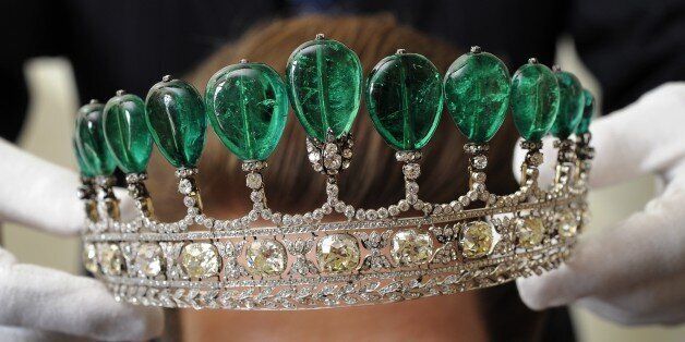 A model poses with an emerald and diamond tiara during a Sotheby's auction press preview on May 11, 2011 in Geneva. The tiara composed of 11 Colombian pear-shaped emeralds and weighing over 500 carats, was created for Princess Katharina Henckel von Donnersmarck and is alleged to be the most valuable tiara to have appeared at auction for over 30 years. It is expected to sell between US Dollars 5.1-10.2m, Euros 3.5-7m) when it is auctioned at the Magnificent and Noble Jewels on May 17 in Geneva. AFP PHOTO / FABRICE COFFRINI (Photo credit should read FABRICE COFFRINI/AFP/Getty Images)
