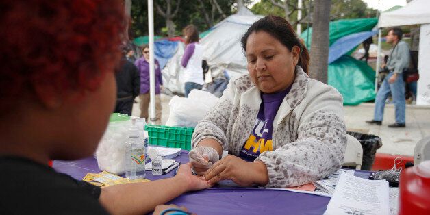 LOS ANGELES, CA - NOVEMBER 19: Nurse Enedina Rosas takes a blood sample for a glucose test at the Healthcare for the 99% Health Fair, organized by the United Healthcare Workers union (SEIU-UHW), in the Occupy Los Angeles encampment at City Hall on November 19, 2011 in Los Angeles, California. Though Occupy camps have been broken up by police in most big cities across the nation, the Occupy L.A. camp has persevered with the blessings of Mayor Antonio Villaraigosa and city officials who say that they have not had any serious problems by the campers so far. Concern is rising though among the Occupiers since the office of the Mayor announced that they will not be able to camp on city property indefinitely. (Photo by David McNew/Getty Images)