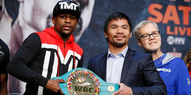 Floyd Mayweather Jr., left, and Manny Pacquiao pose with a WBC belt during a press conference Wednesday, April 29, 2015, in Las Vegas. Mayweather will face Pacquiao in a welterweight boxing match in Las Vegas on May 2. (AP Photo/John Locher)