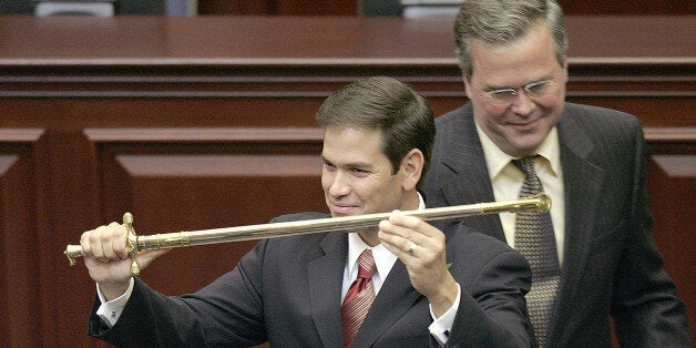 FILE - In this Sept. 13, 2005, file photo, then-Rep. Marco Rubio, R-Miami, left, holds a sword presented to him by then-Gov. Jeb Bush, right, during ceremonies designating Rubio as the next Florida Speaker of the House in Tallahassee, Fla. Devoted political allies for more than a decade, the alliance between Bush and Rubio is beginning to splinter as the one-time mentor and his political protégé face off in the race for the Republican presidential nomination. (AP Photo/Phil Coale, File)