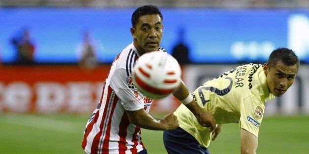 Marco Fabian(L) of Chivas vies for the ball with Paul Aguilar of America, during their Mexican Clausura 2015 tournament football match on April 26, 2015, at Omnilife stadium in Guadalajara City, Mexico. AFP PHOTO/HECTOR GUERRERO (Photo credit should read HECTOR GUERRERO/AFP/Getty Images)