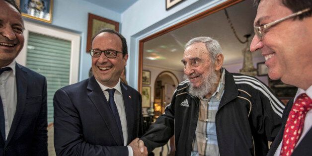 Cuba's former leader Fidel Castro, second right, shakes hands with French President Francois Hollande, while accompanied by Cuba's Foreign Minister Bruno Rodriguez, right, and an unidentified person, left, in Havana, Cuba, Monday, May 11, 2015. Hollande is the first French leader to visit the island nation in more than a century and also the first Western leader to travel to Cuba since the surprise announcement in December of a rapprochement between Washington and Havana. (AP Photo/Alex Castro)
