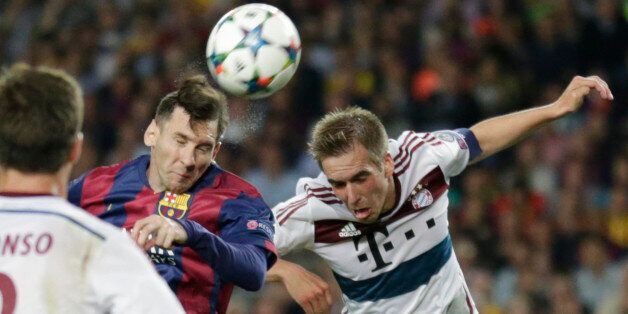 Barcelona's Lionel Messi, left, and Bayern's Philipp Lahm go for a header during the Champions League semifinal first leg soccer match between Barcelona and Bayern Munich at the Camp Nou stadium in Barcelona, Spain, Wednesday, May 6, 2015. (AP Photo/Manu Fernandez)