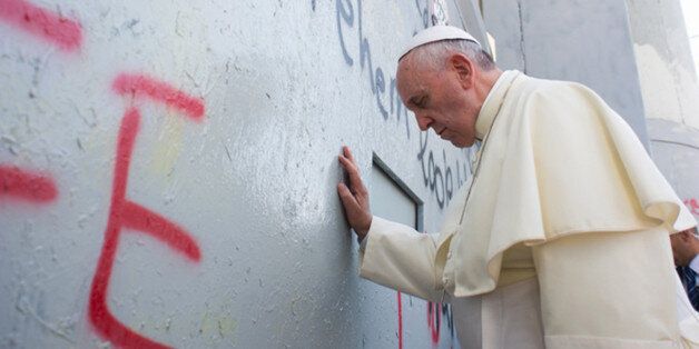 Pope Francis made a surprise stop at the wall Palestinians abhor as a symbol of Israeli oppression in Bethlehem, Israel on May 25, 2014. In an image likely to become the most emblematic of his trip to the holy land, Francis rested his forehead against the concrete structure that separates Bethlehem from Jerusalem, and prayed silently. Photo by ABACAPRESS.COM