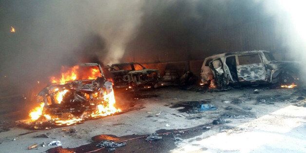 Vehicles burn, that authorities say caught fire during a gunbattle, in a warehouse at Rancho del Sol, near Ecuanduero, in western Mexico, Friday, May 22, 2015. At least 43 people died Friday in what authorities described as a fierce, three-hour gunbattle between federal forces and suspected drug gang gunmen at the ranch. (AP Photo/Oscar Pantoja Segundo)
