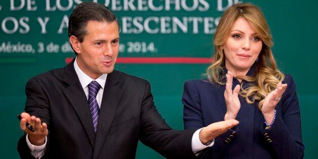 Mexico's President Enrique Pena Nieto and first lady Angelica Rivera attend a signing ceremony for a new law that further protects children at Los Pinos presidential residence in Mexico City, Wednesday, Dec. 3, 2014. (AP Photo/Eduardo Verdugo)