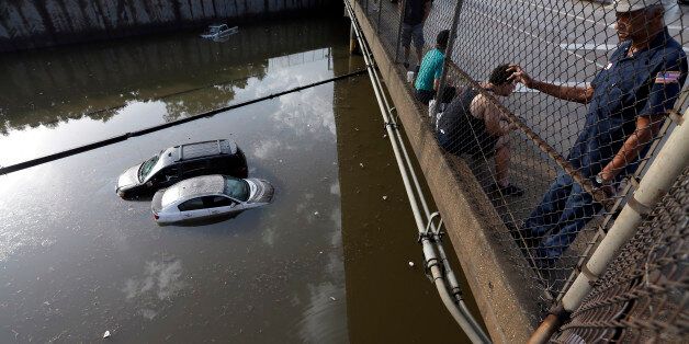 Cars sit in floodwaters along Interstate 45 after heavy overnight rain flooded parts of the highway in Houston, Tuesday, May 26, 2015. Several major highways in the Houston area are closed due to high water. (AP Photo/David J. Phillip)