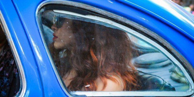 US music star Rihanna rides an old car in Havana, on May 28, 2015. AFP PHOTO/YAMIL LAGE (Photo credit should read YAMIL LAGE/AFP/Getty Images)