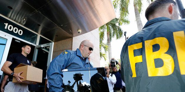 MIAMI BEACH, FL - MAY 27: FBI agents carry boxes and computers from the headquarters of CONCACAF after it was raided on May 27, 2015 in Miami Beach, Florida. The raid is part of an international investigation of FIFA where nine FIFA officials and five corporate executives were charged with racketeering, wire fraud and money laundering conspiracies. (Photo by Joe Skipper/Getty Images)