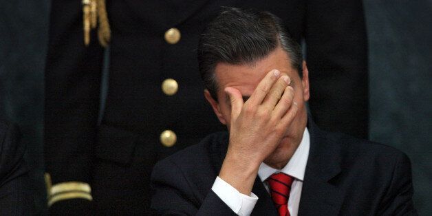 FILE - In this Wednesday, Jan. 21, 2015, file photo, Mexico's President Enrique Pena Nieto attends a ceremony promoting housing for low income families, single mothers and members of the armed forces at Los Pinos presidential residence in Mexico City. Pena Nieto has also seen his pro-business agenda derailed by allegations of corruption and the disappearance of 43 students after they were handed over by police to local drug traffickers. (AP Photo/Marco Ugarte, File)