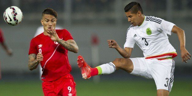 Peru's Paolo Guerrero (L) vies for the ball Mexico's Hugo Ayala (R) during a friendly football match at the National Stadium in Lima on June 3, 2015, ahead of the 44th edition of the Copa America to be held in Chile from June 11 to July 4. AFP PHOTO / ERNESTO BENAVIDES (Photo credit should read ERNESTO BENAVIDES/AFP/Getty Images)