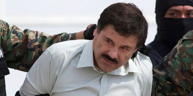 FILE - In this Feb. 22, 2014 file photo, Joaquin "El Chapo" Guzman, head of Mexicoâs Sinaloa Cartel, is escorted to a helicopter in Mexico City following his capture overnight in the beach resort town of Mazatlan. (AP Photo/Eduardo Verdugo, File)