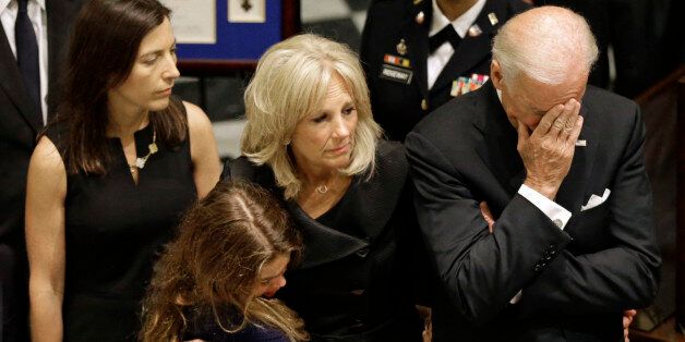 U.S. Vice President Joe Biden, right, rests his head in his hand during a viewing for his son, former Delaware Attorney General Beau Biden, Thursday, June 4, 2015, at Legislative Hall in Dover, Del. Standing with Vice President Biden are Beau Biden's widow, Hallie, from left, and daughter Natalie, and the the vice president's wife Jill. Beau Biden died of brain cancer Saturday at age 46. (AP Photo/Patrick Semansky, Pool)