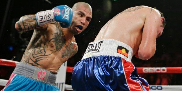 Miguel Cotto, left, of Puerto Rico, punches Daniel Geale, of Australia, during the second round of a boxing match Saturday, June 6, 2015, in New York. (AP Photo/Frank Franklin II)